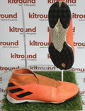 Side and sole view of adidas Nemesis orange astro football boots on artificial grass