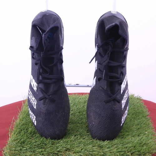 Pair of adidas Predator Demonscale black football boots viewed from the front on artificial grass