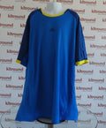 Front view of blue adidas training top with yellow accents