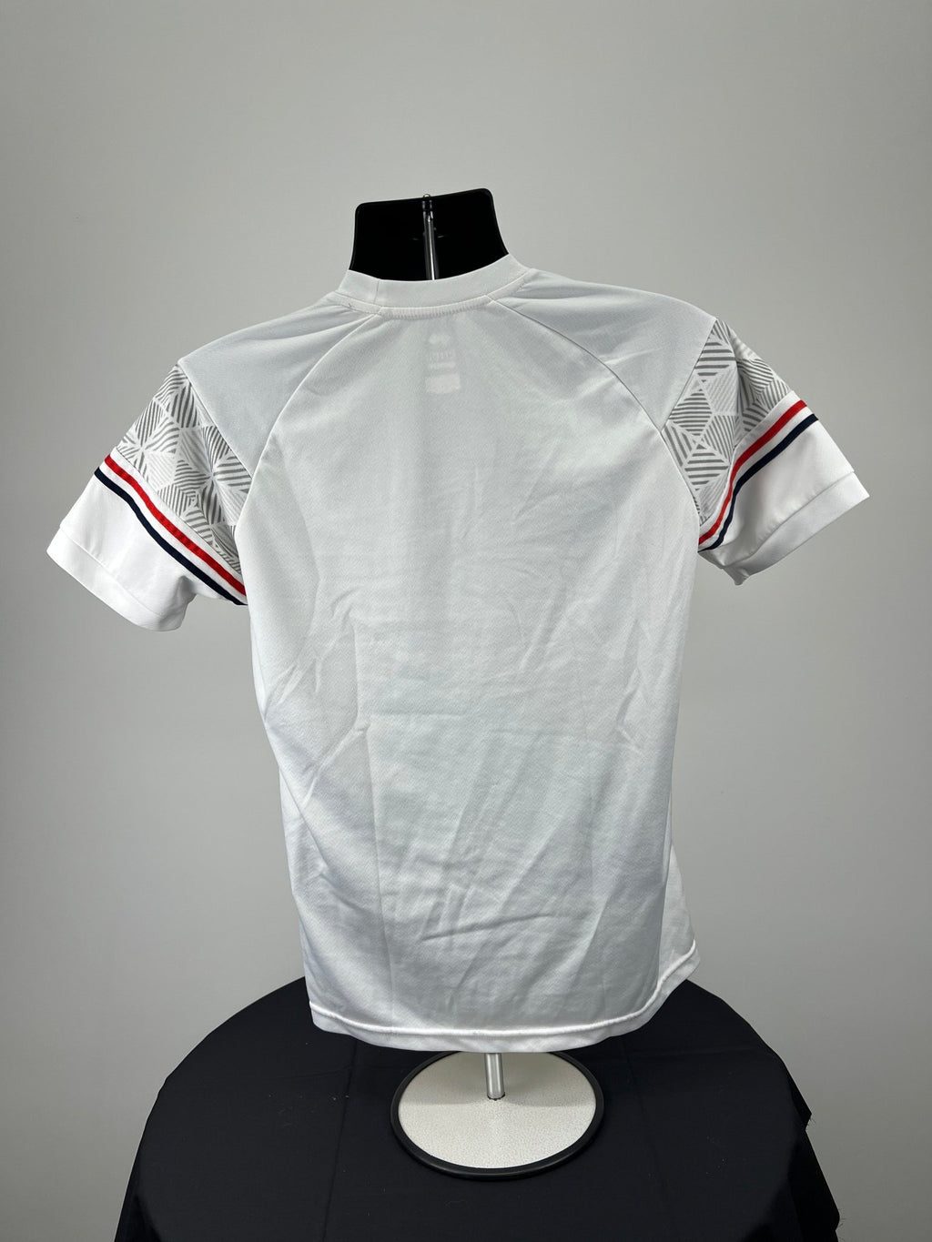 Back view of Men’s England Volleyball white t-shirt showing plain white back and striped sleeves