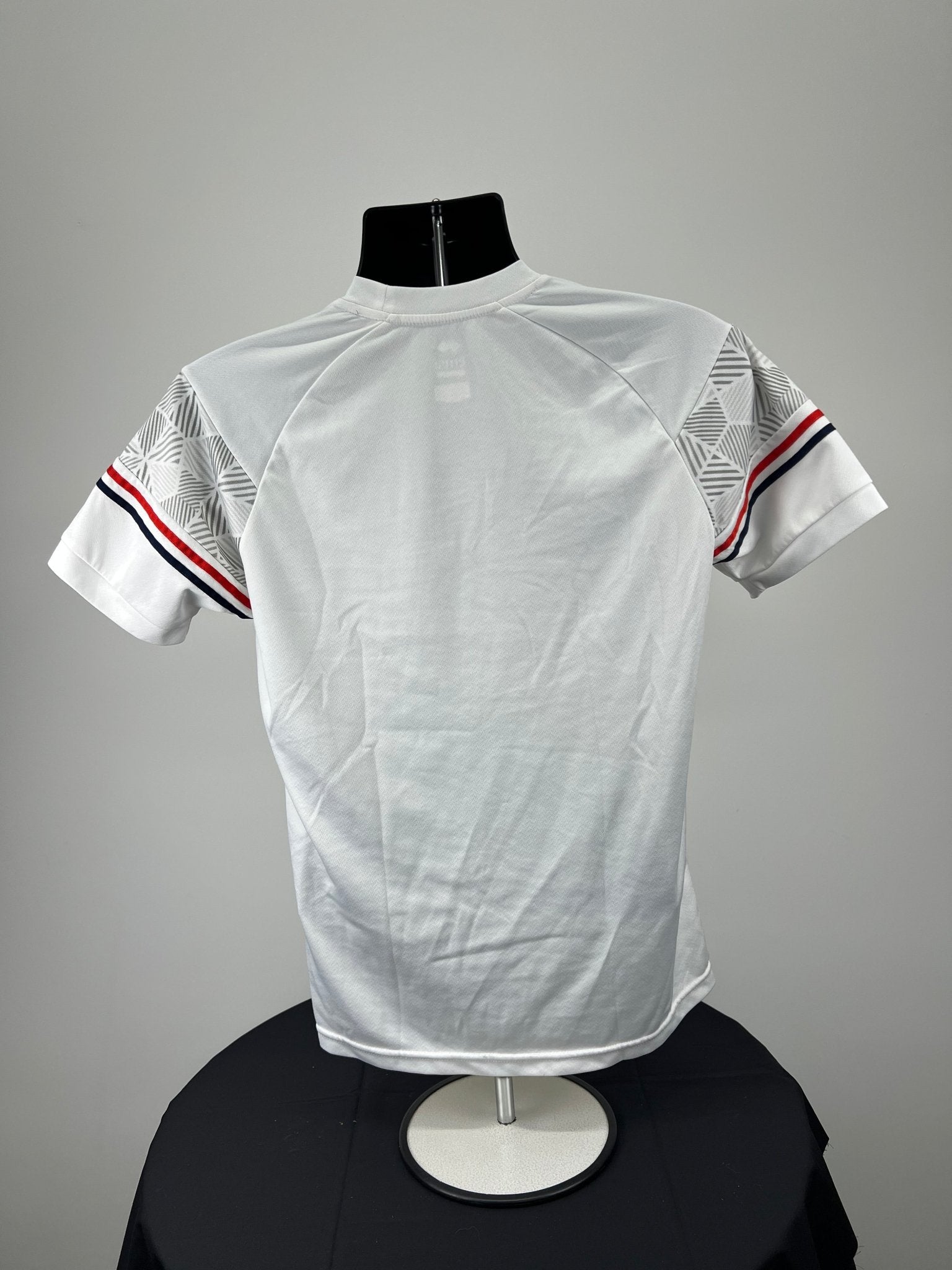 Back view of Men’s England Volleyball white t-shirt showing plain white back and striped sleeves