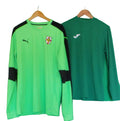 Green Puma goalkeeper top with black details and Joma green long-sleeve underlayer on hangers