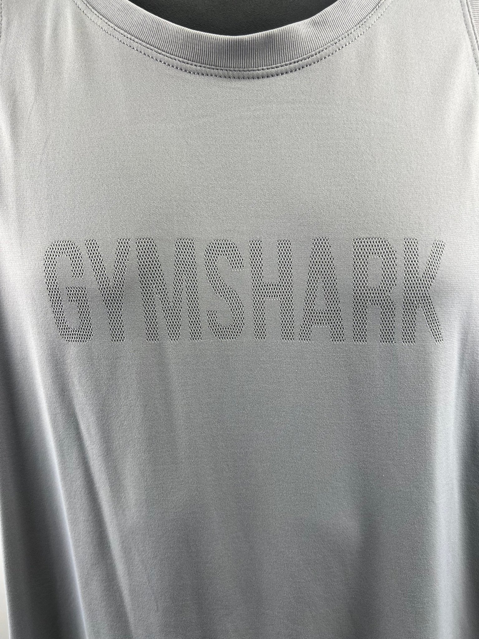 Close-up view of the front Gymshark logo on a grey vest