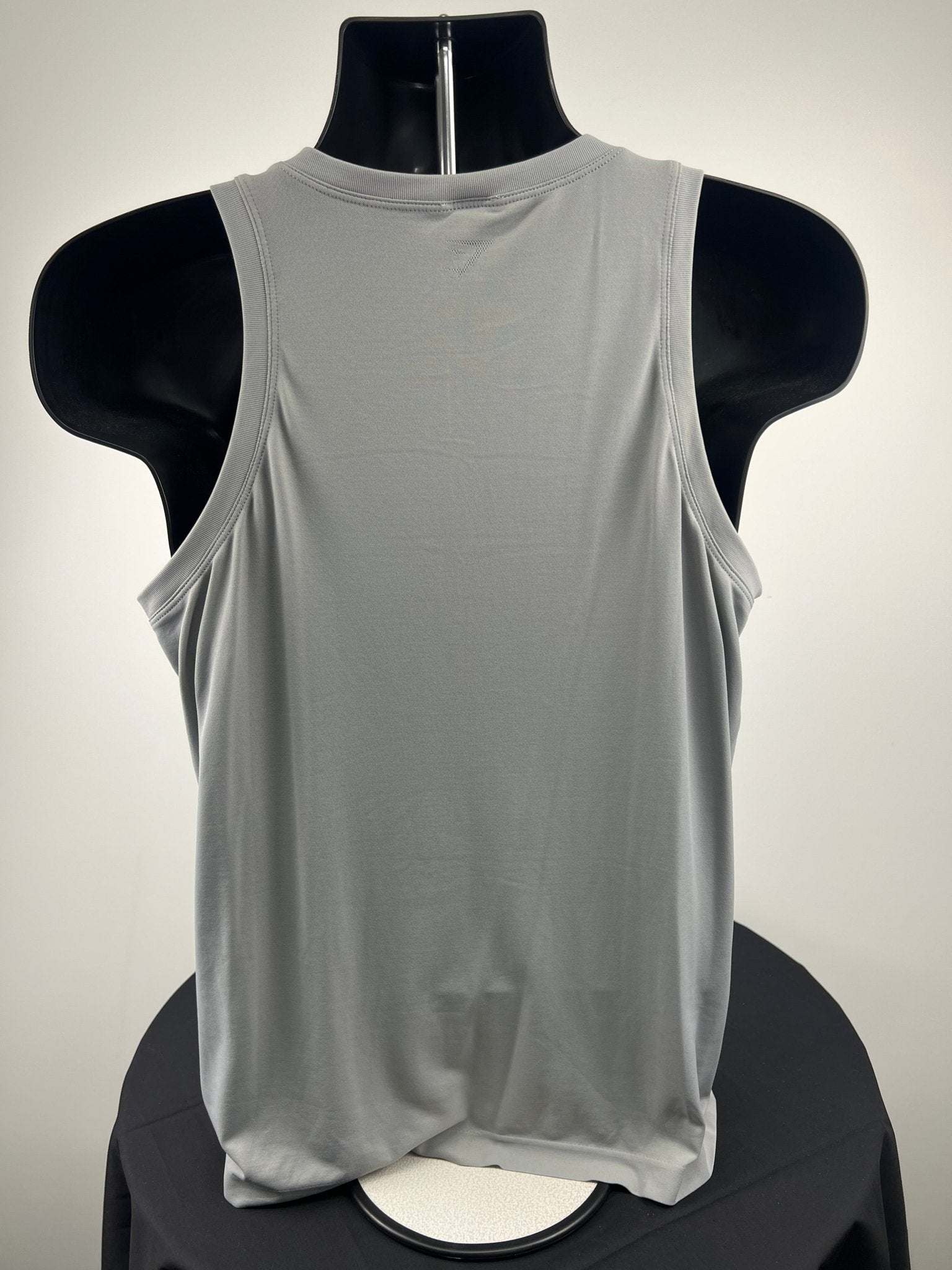 Back view of a grey Gymshark sleeveless vest on mannequin