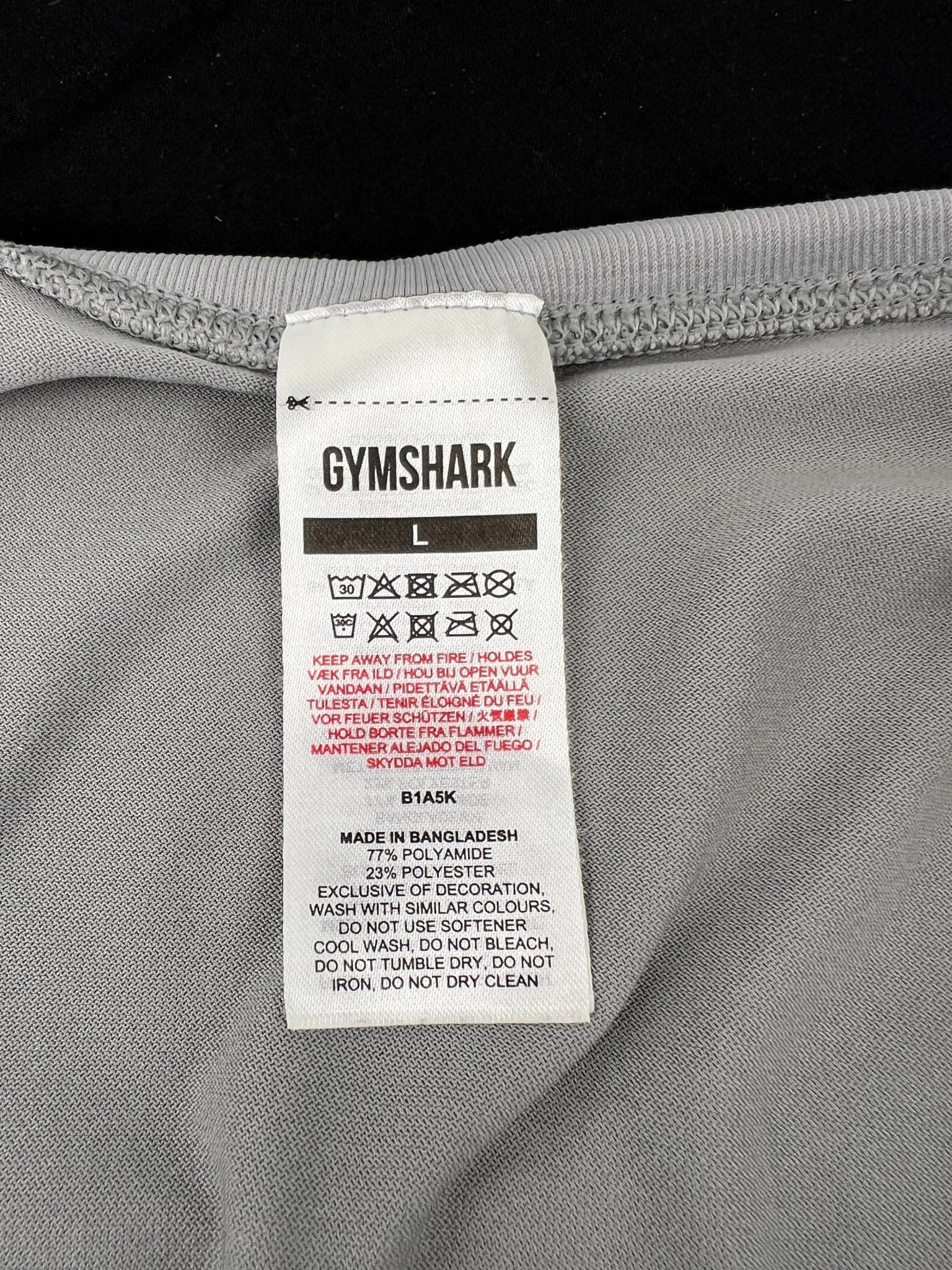 Care label showing material composition and instructions for Gymshark vest