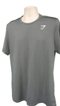 Front view of men's grey Gymshark sports top on mannequin against green background
