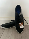 Pair of black Kipsta Astros football boots with one shoe upright and one lying flat