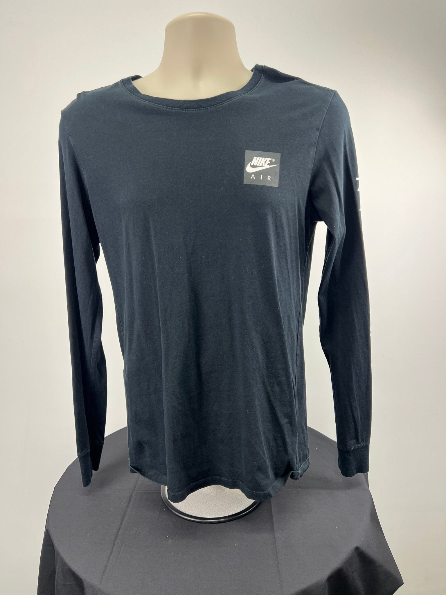 Front view of the Nike Air men's long sleeve top in black