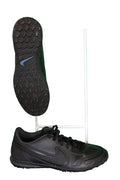 Men's black Nike astro football boots with textured sole on green background
