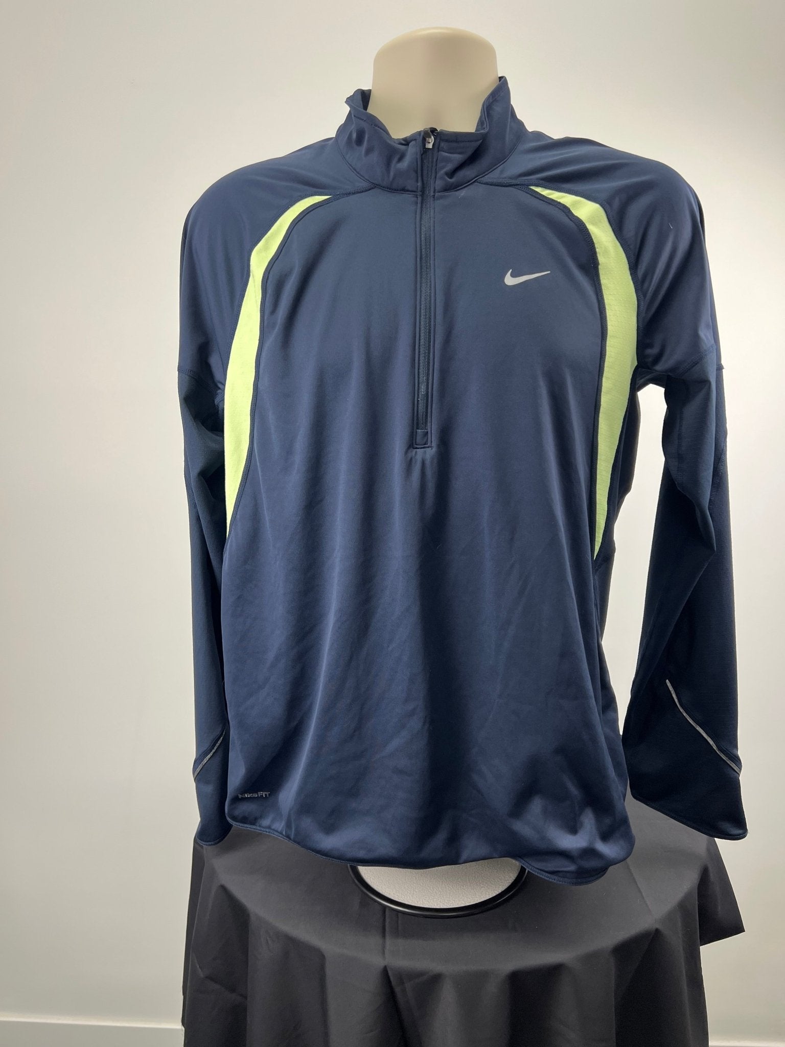 Front view of dark blue Nike Dri-FIT 1/2 zip running top with light striping and long sleeves