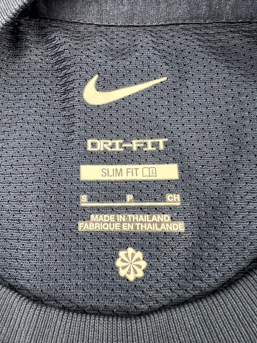Interior label of Nike Dri-FIT slim fit t-shirt showing size and material details