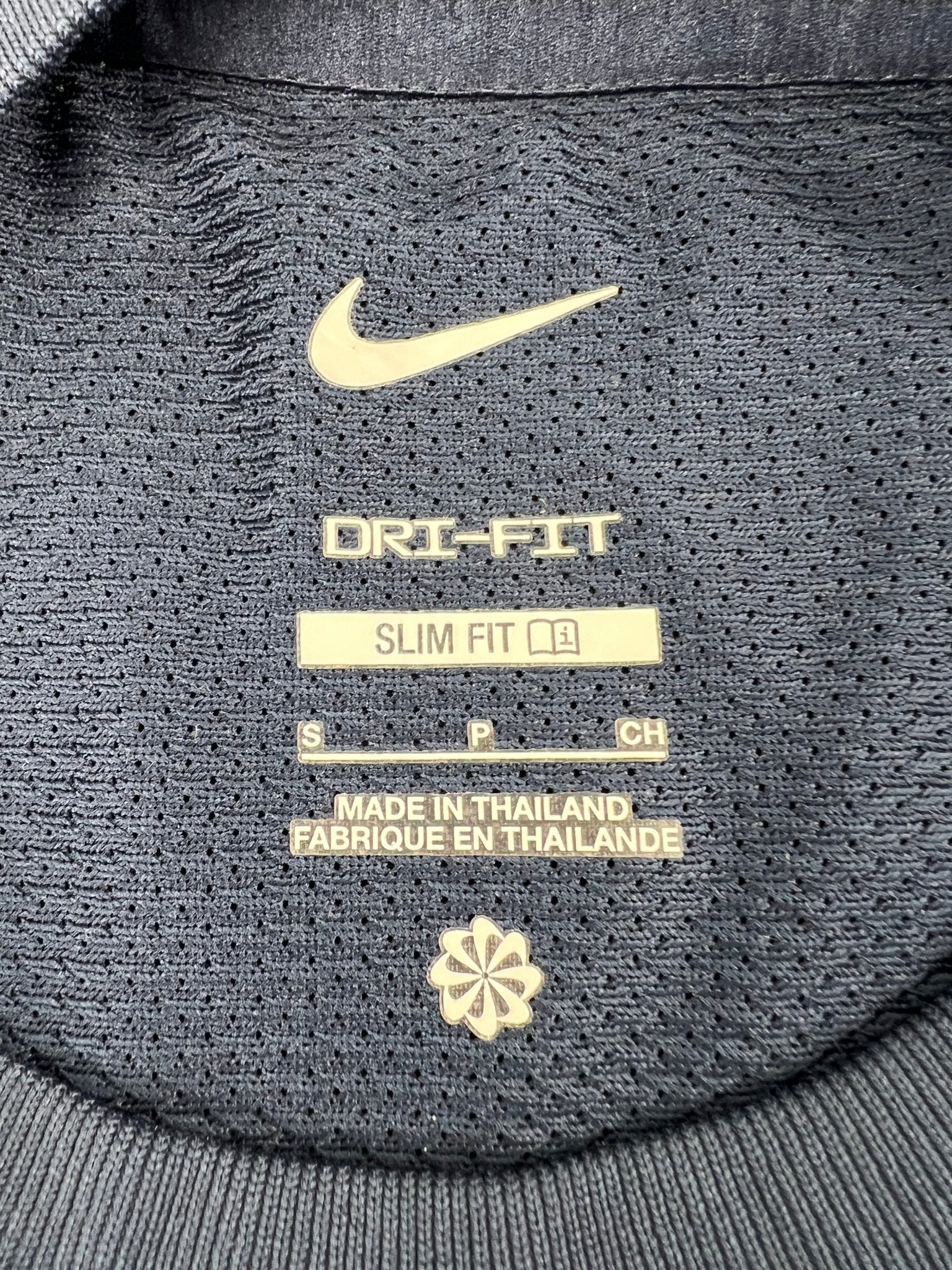 Interior label of Nike Dri-FIT slim fit t-shirt showing size and material details