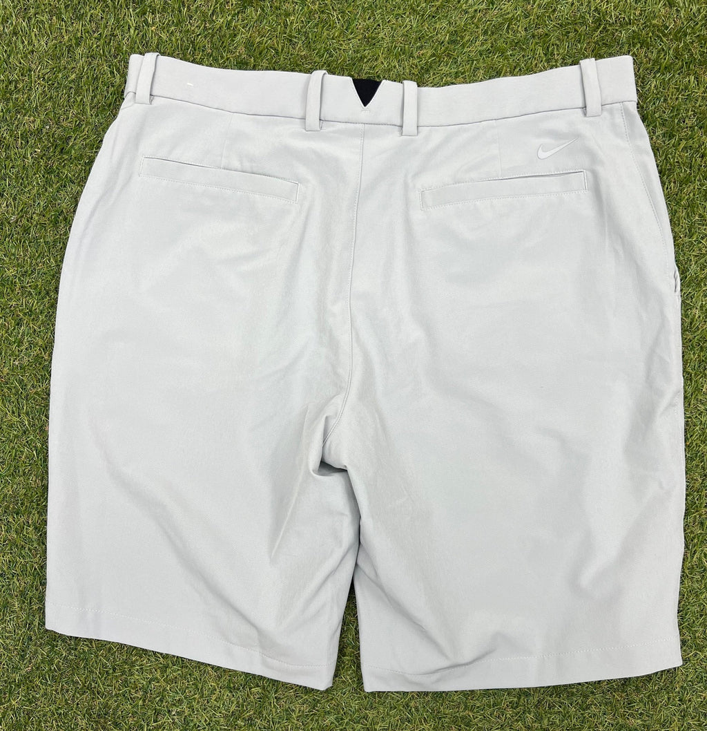 Back view of grey Nike golf shorts showing pockets and small Nike logo