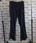 Puma navy tracksuit bottoms with white side stripe hanging on rail