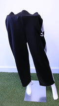 Front view of black and white Puma tracksuit bottoms displayed on mannequin