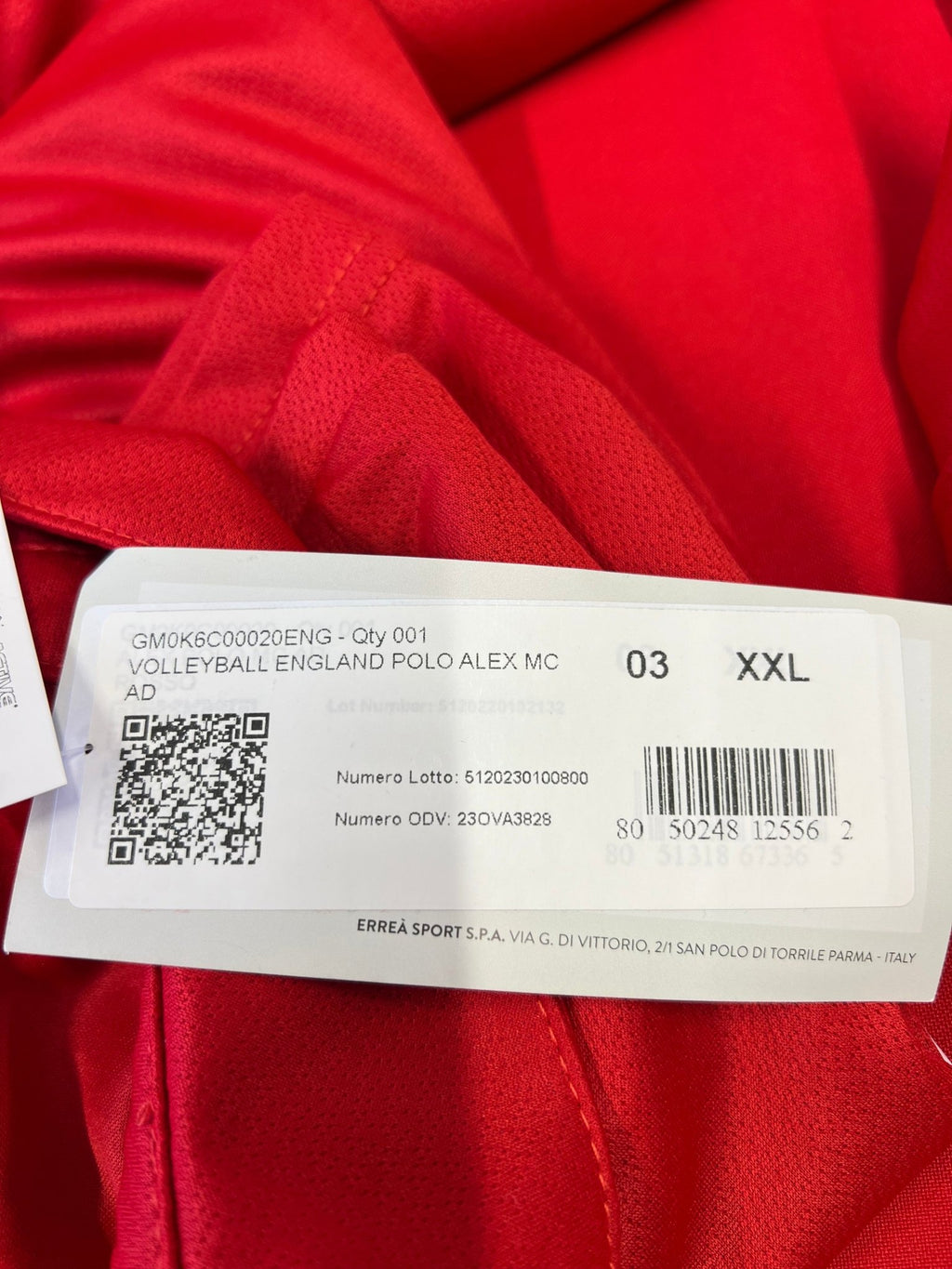 Close-up of label showing size XXL and product details on men's Volleyball England polo shirt