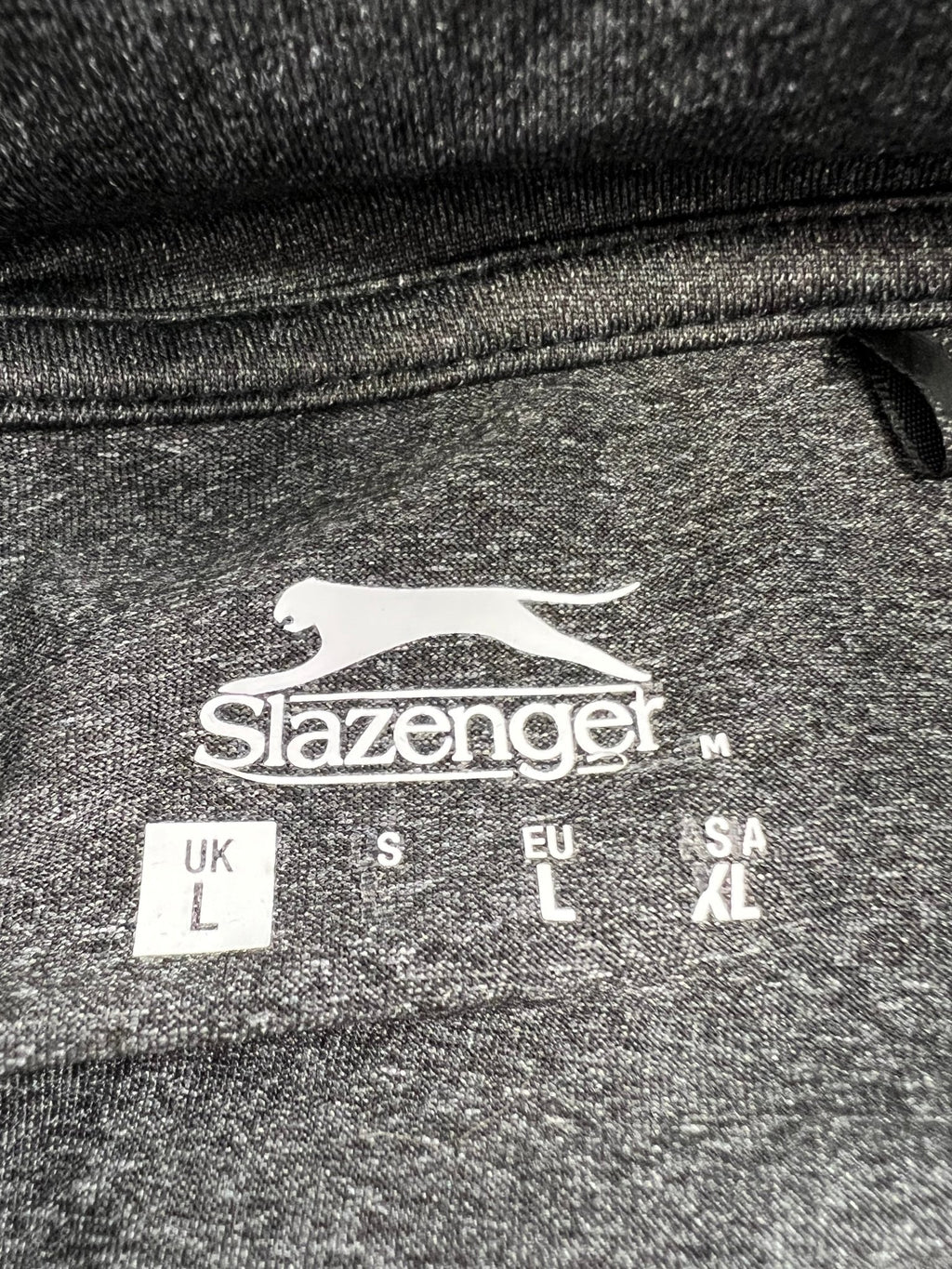 Close-up of the Slazenger logo and size label on the inside collar