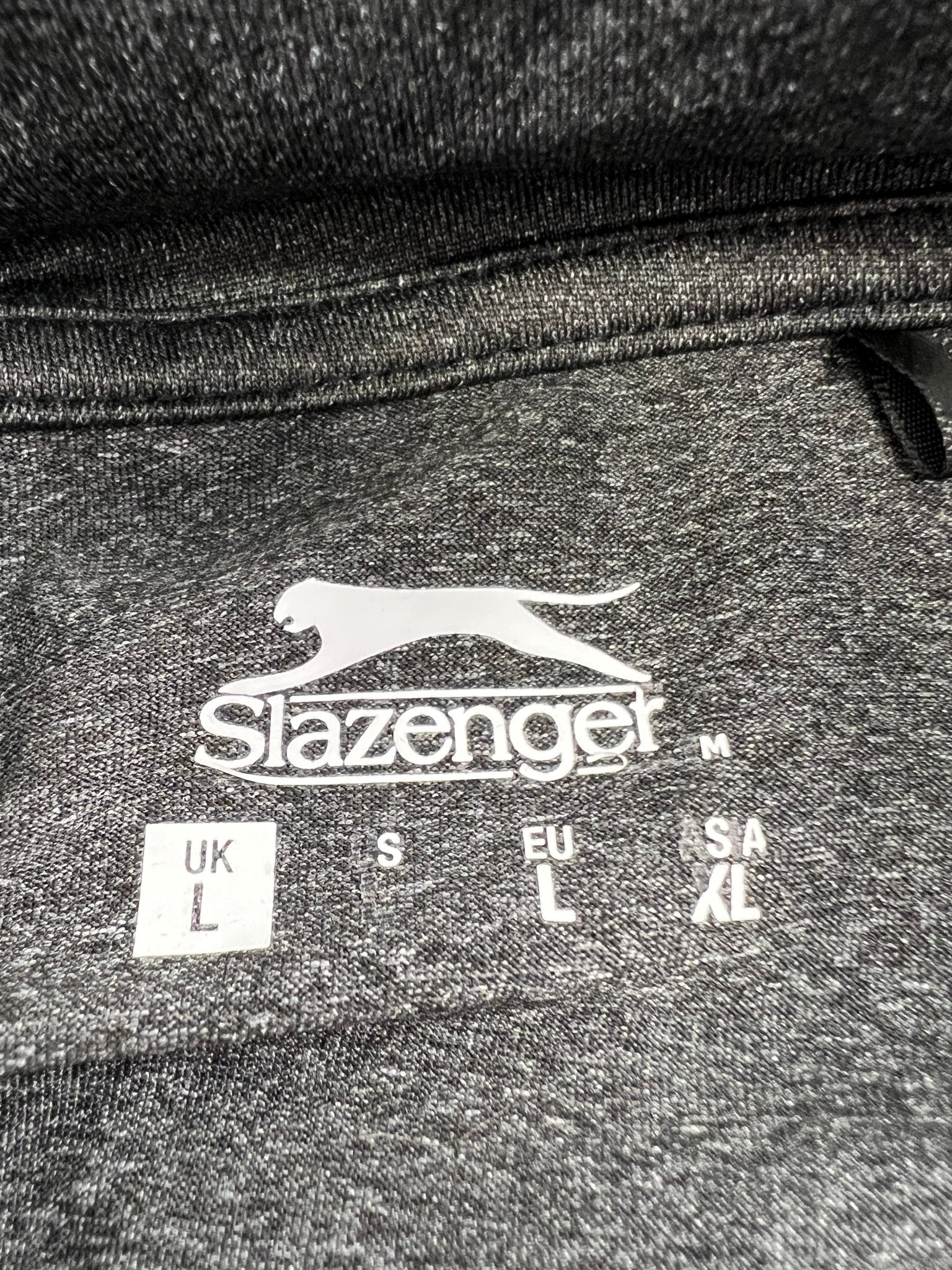 Close-up of the Slazenger logo and size label on the inside collar