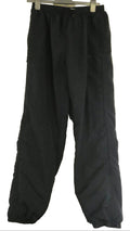 Pair of black Slazenger waterproof trousers hanging