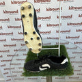 Pair of black Sondico football boots with visible studded sole on display