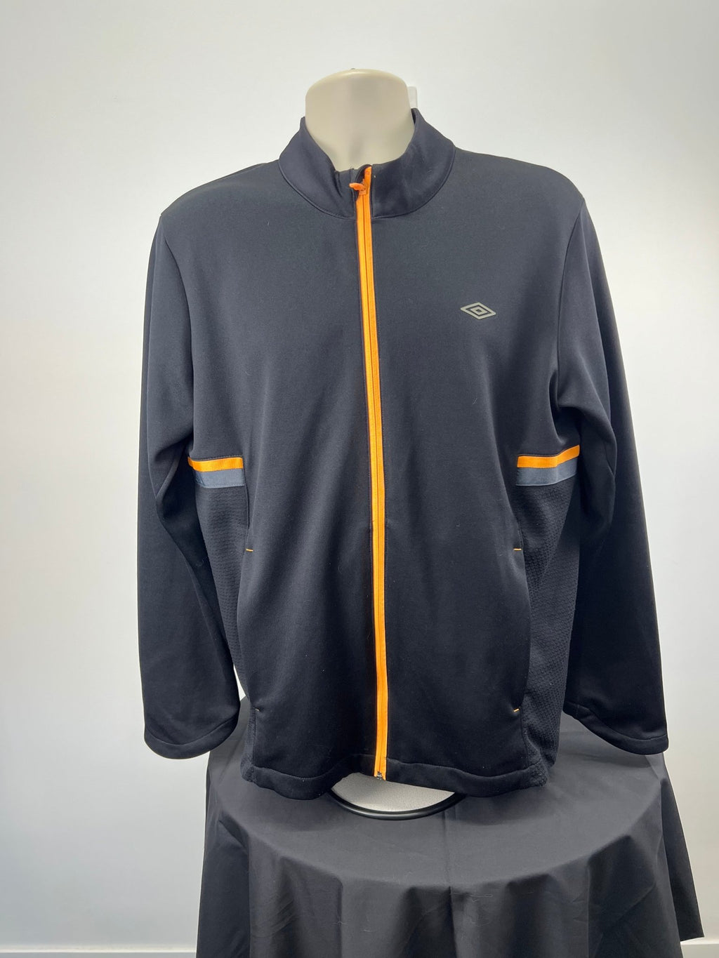Front view of black Umbro full zip jacket with orange details, size L