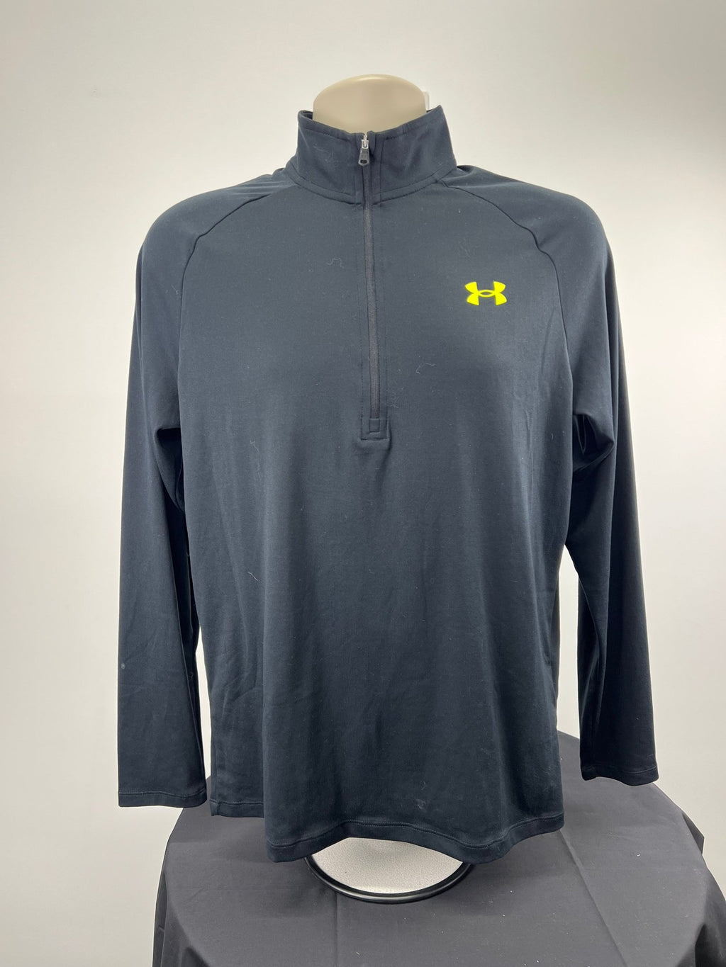 Front view of black Under Armour 1/4 zip top in medium
