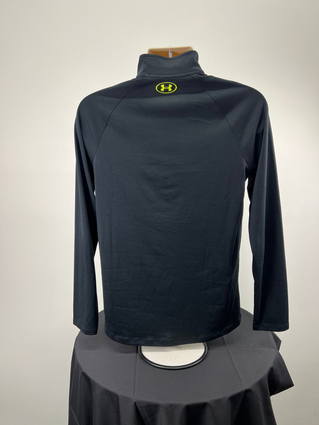 Back view of black Under Armour 1/4 zip top with yellow logo