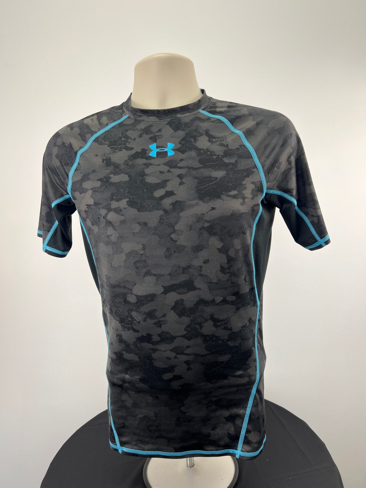 Front view of Under Armour black and blue compression top, size medium