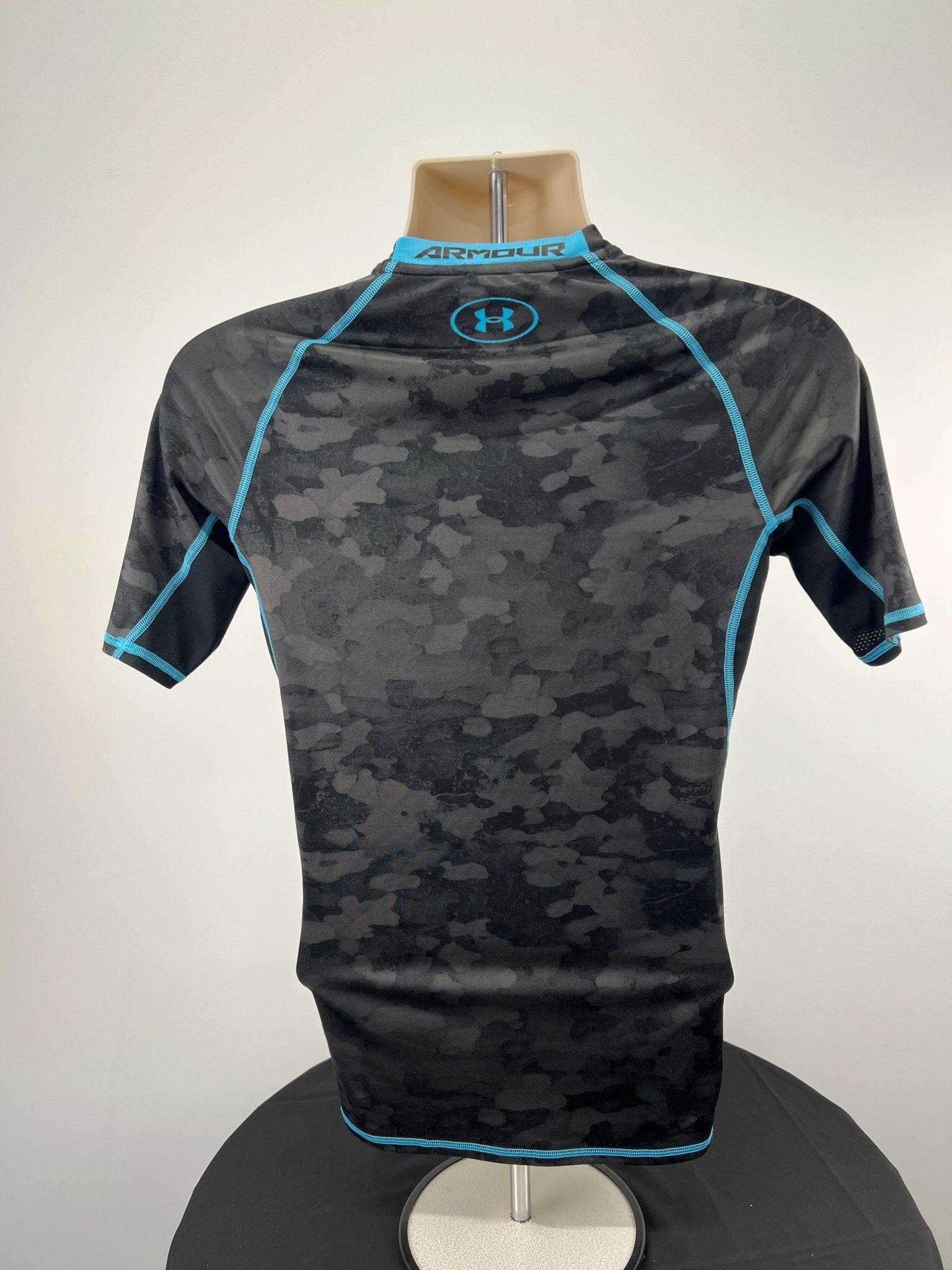 Back view of Under Armour black and blue compression top, size medium