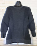 Front view of dark grey Under Armour jumper displayed on mannequin against white brick wall