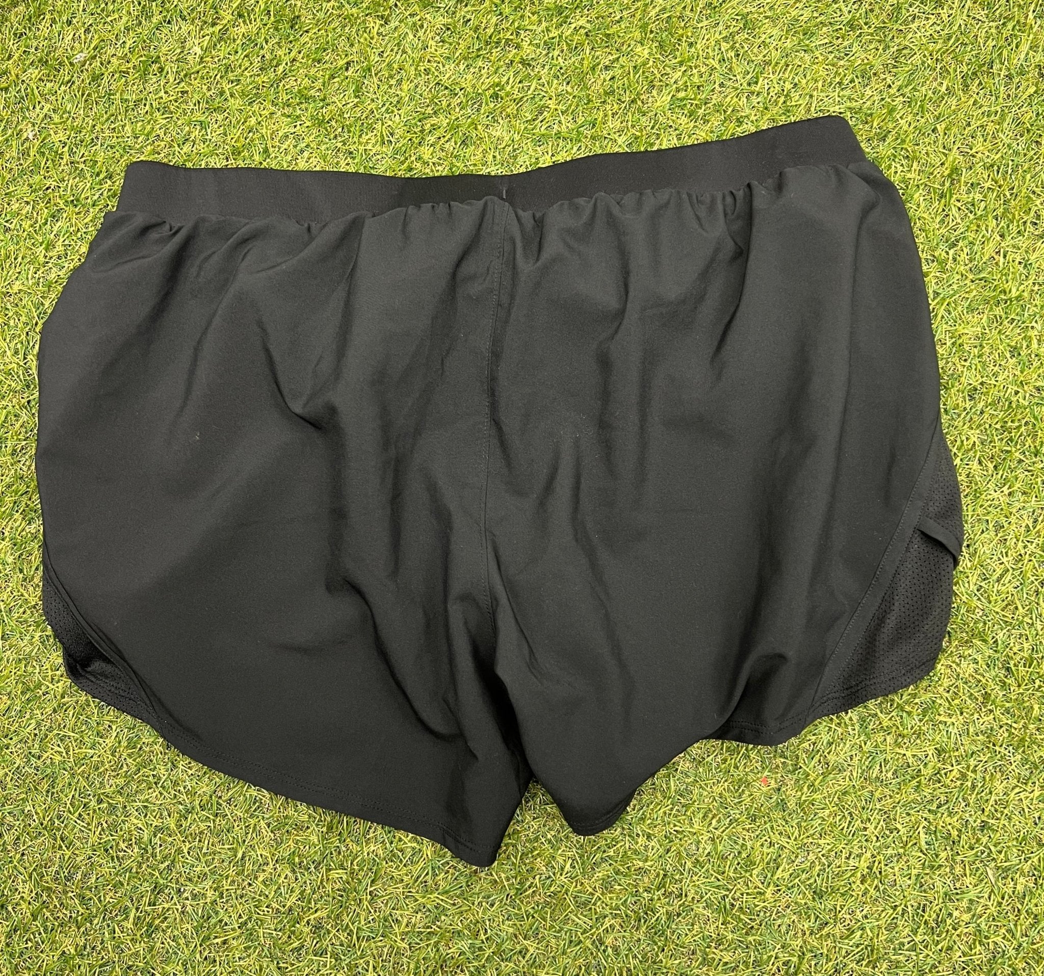 Rear view of Men's Under Armour loose fit black running shorts size large