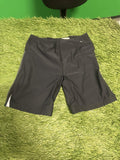 Nike black athletic shorts on a green textured surface