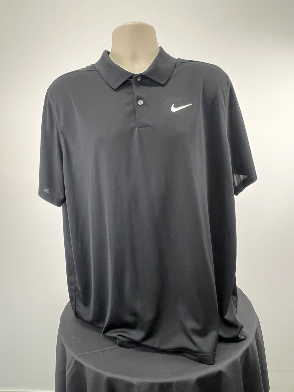 Front view of black Nike Dri-FIT short sleeve polo top in XL