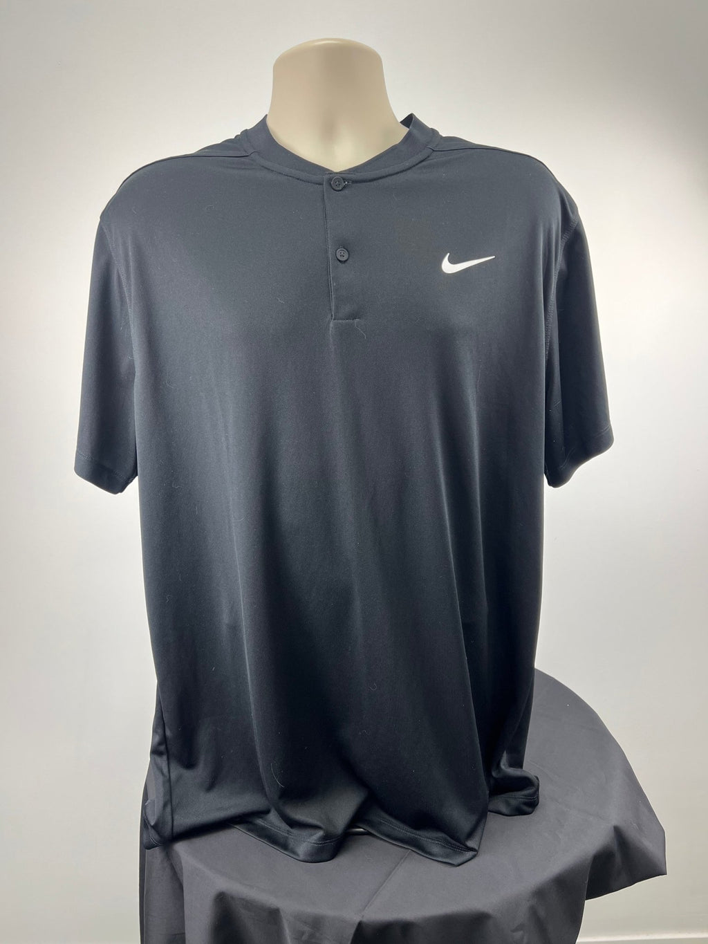 Front view of black Nike Dri-FIT top with button detail in size XL