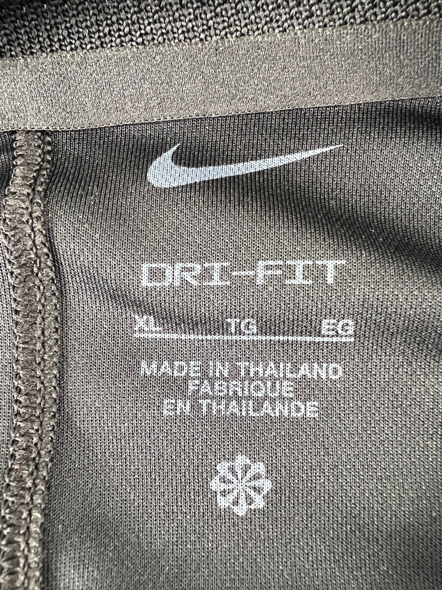 Close-up of Nike Dri-FIT label showing size XL