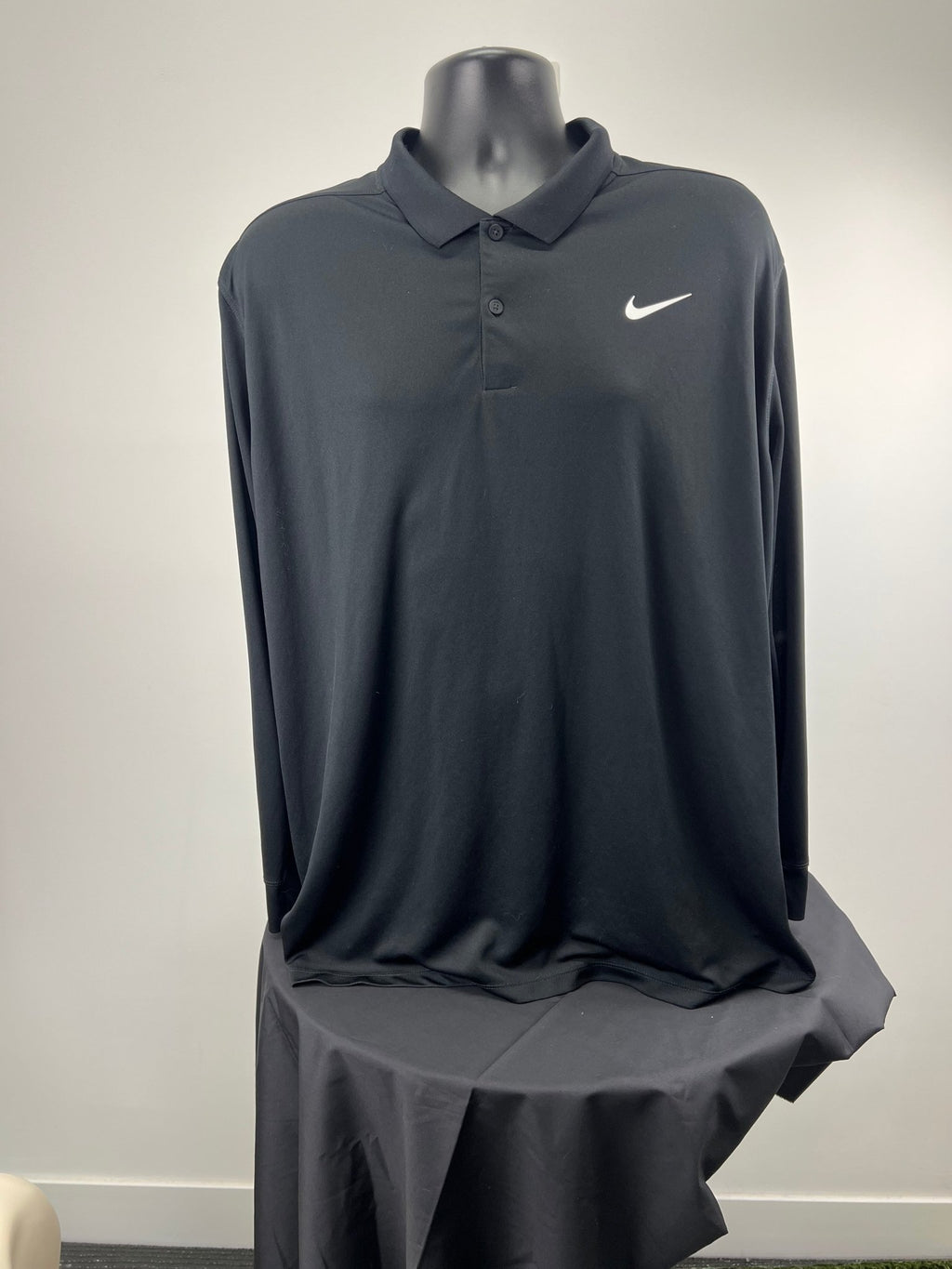 Front view of black Nike long sleeve polo shirt, XL