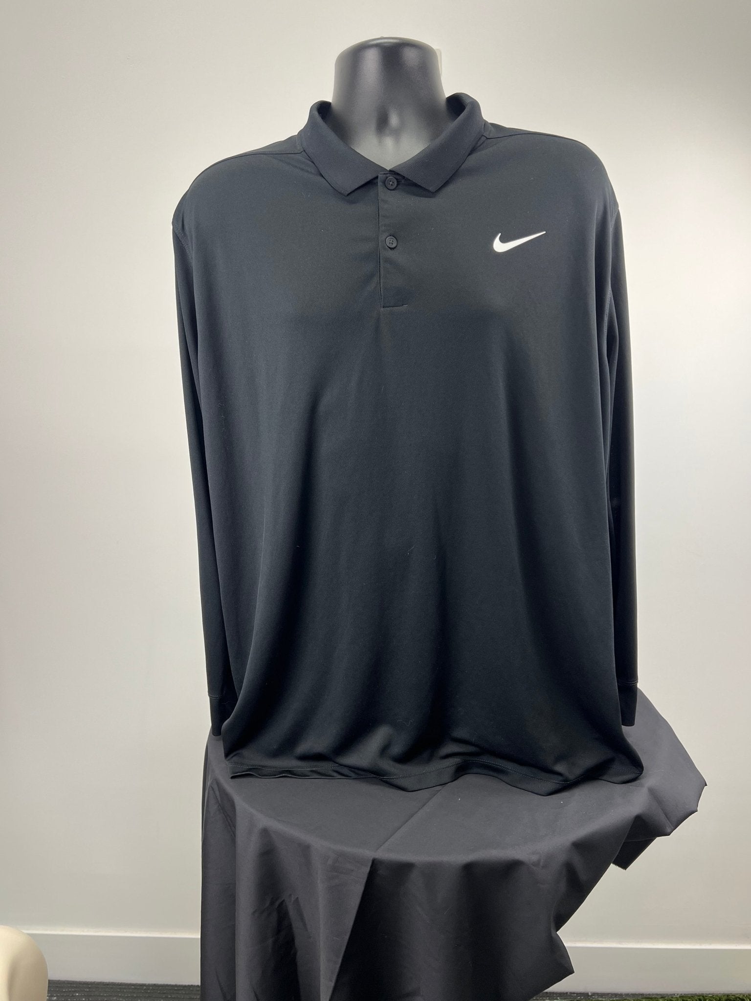 Front view of black Nike long sleeve polo shirt, XL