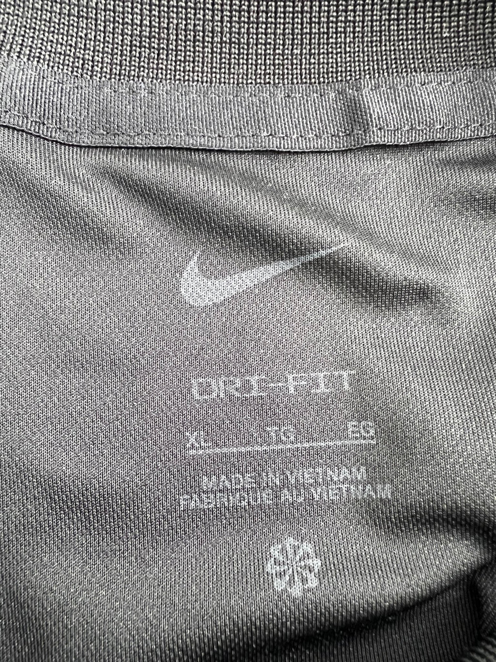 Close-up of the Nike Dri-FIT XL tag inside the shirt