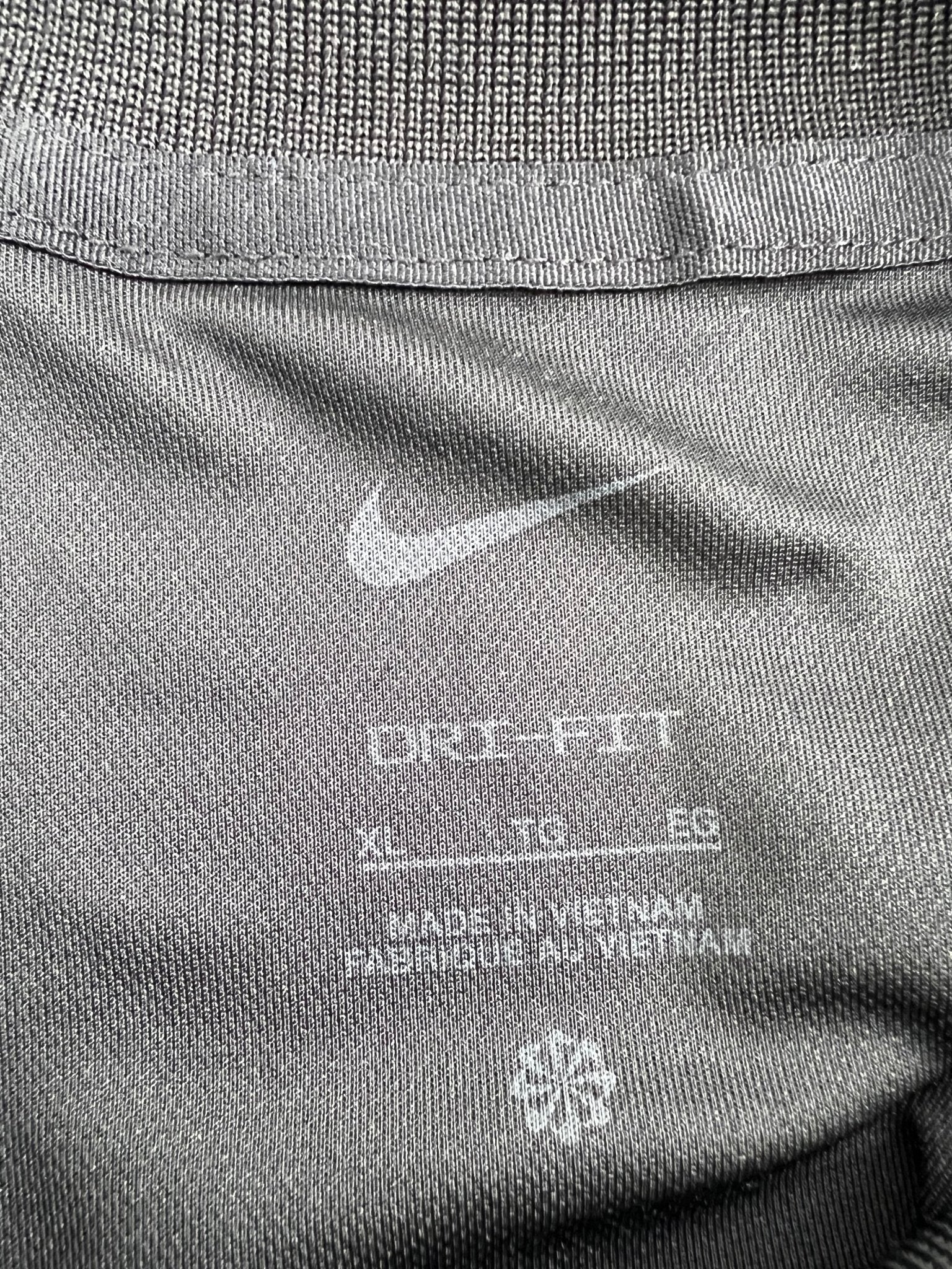 Close-up of the Nike Dri-FIT XL tag inside the shirt