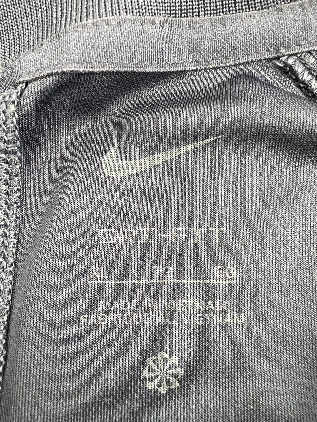 Close-up of Nike Dri-FIT tag and fabric label, size XL