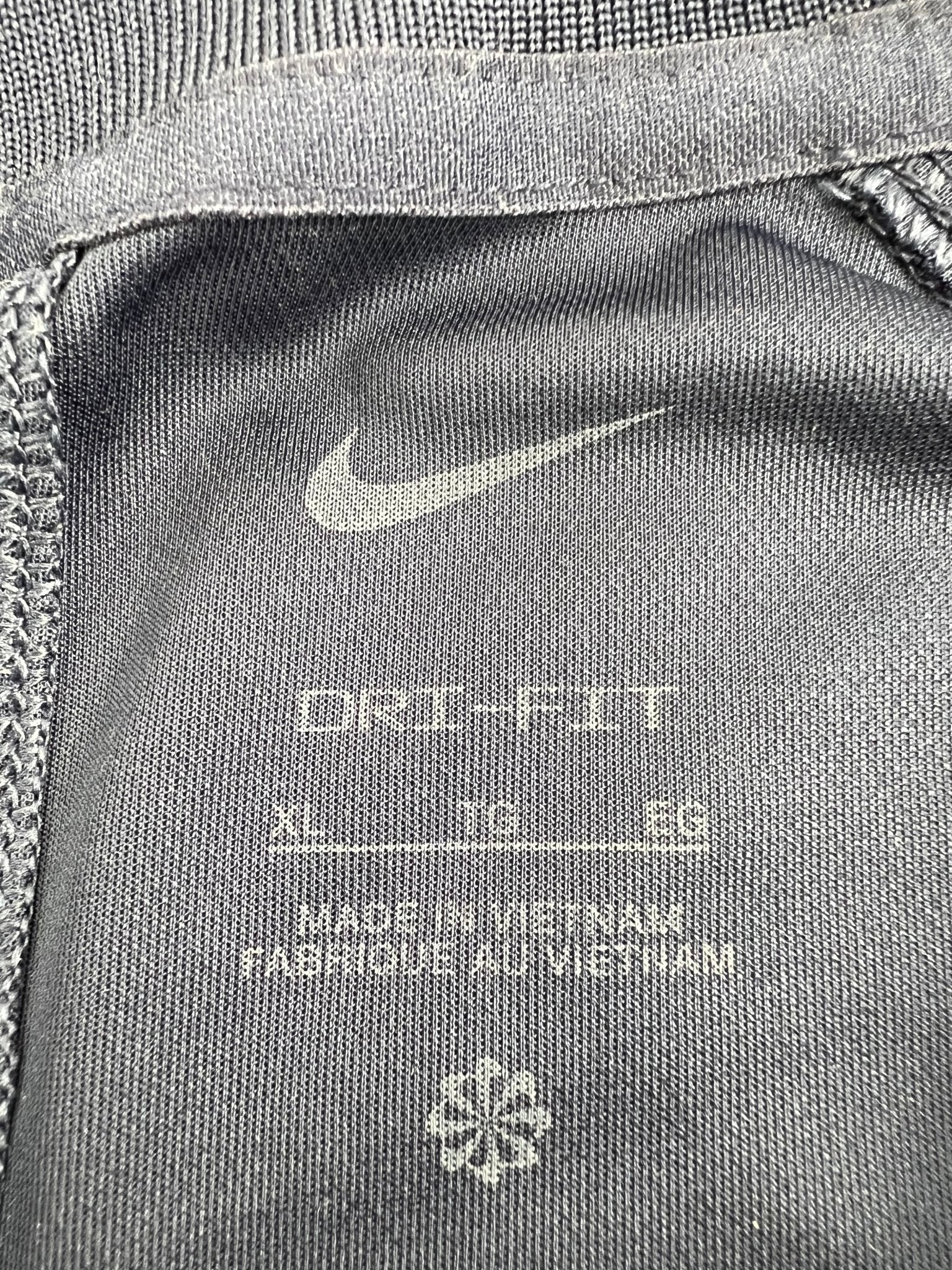 Close-up of Nike Dri-FIT tag and fabric label, size XL