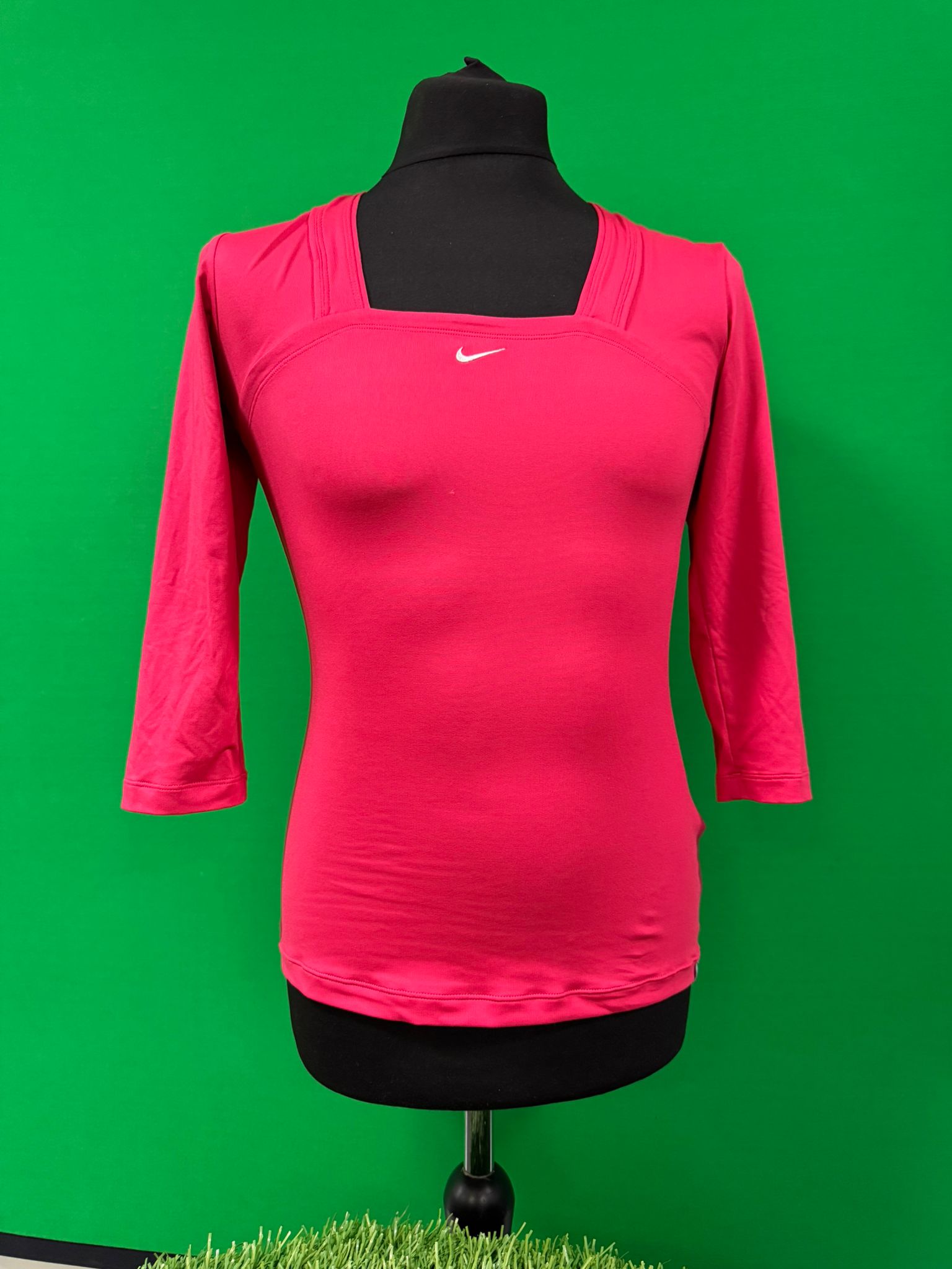 Front view of pink Nike Dri-FIT long sleeve women's top on mannequin