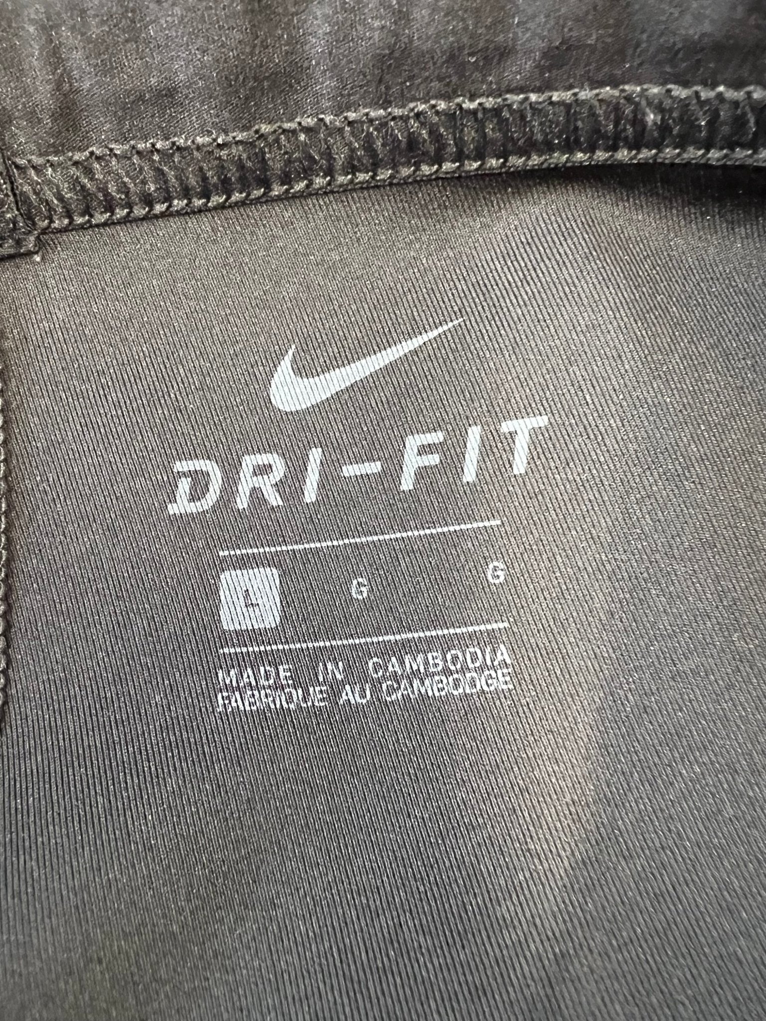 Close-up of inside label showing Nike Dri-FIT logo and size L