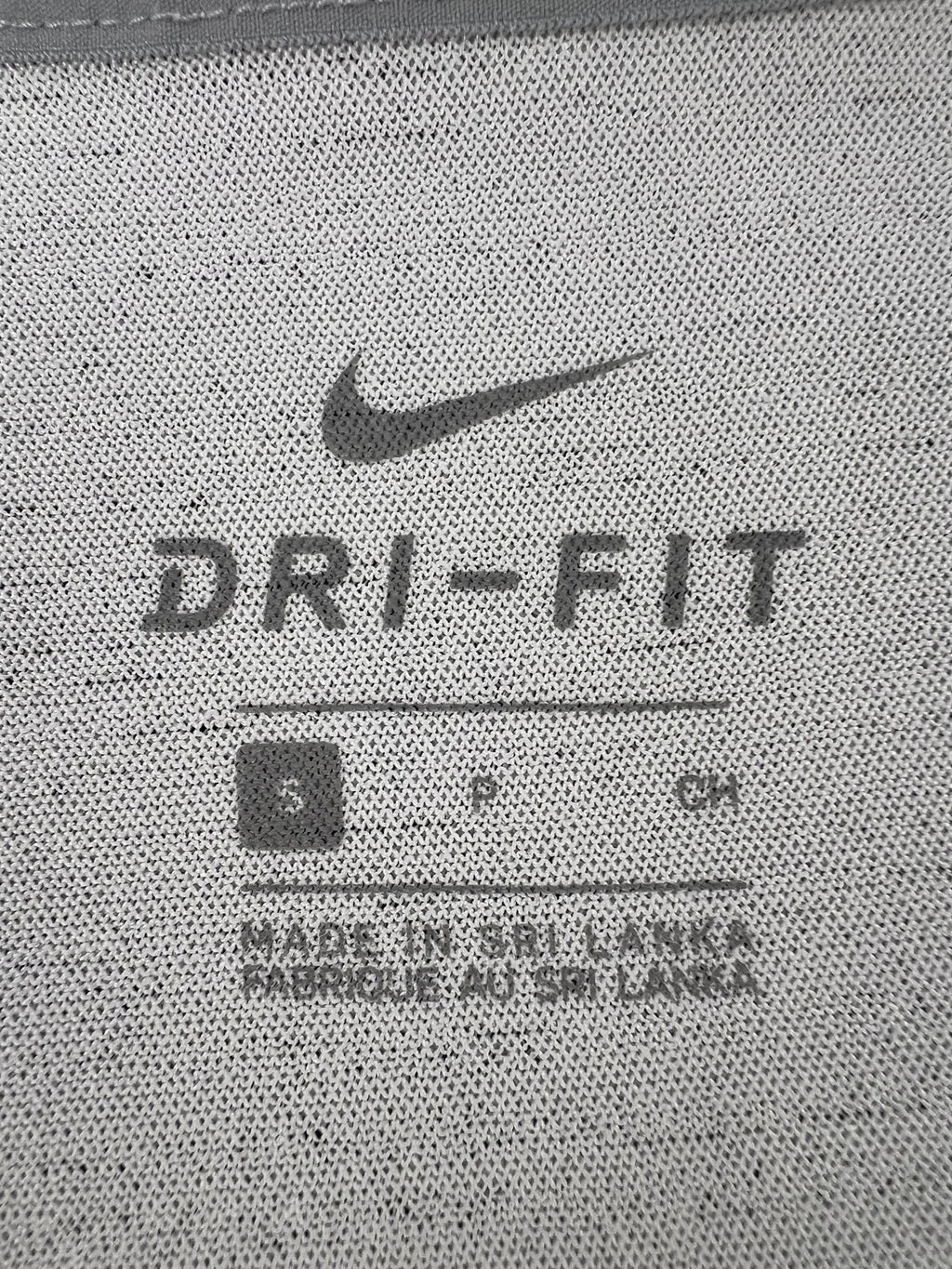 Close up of Nike Dri-FIT label and size S marking