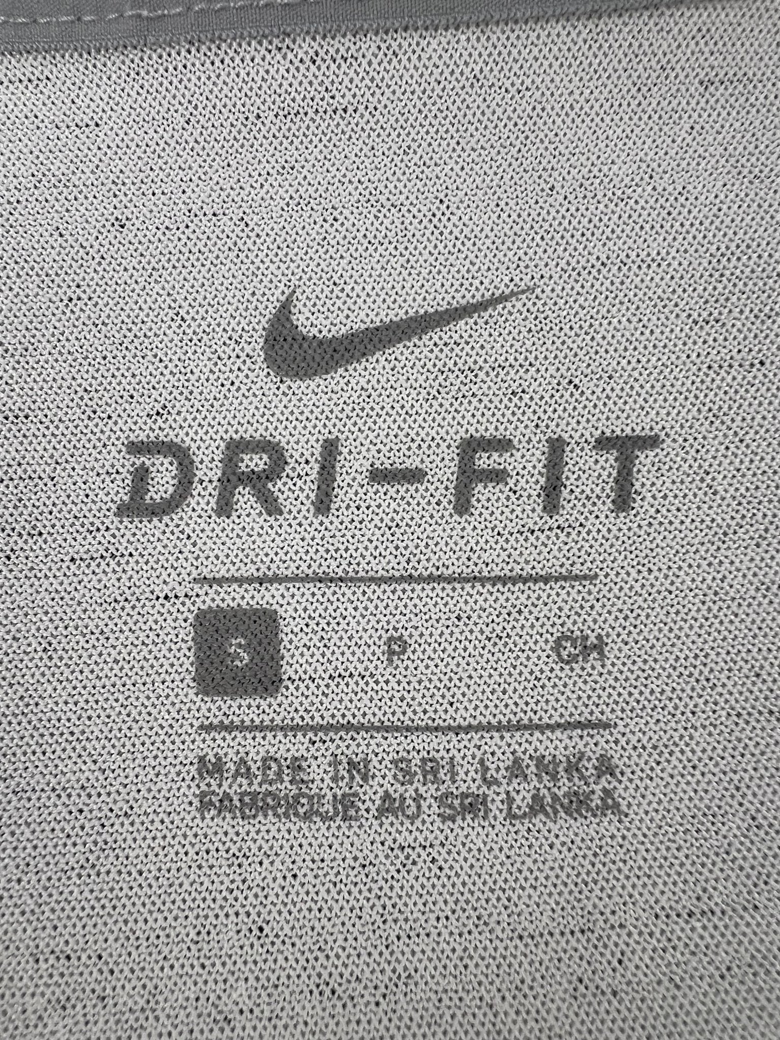 Close up of Nike Dri-FIT label and size S marking