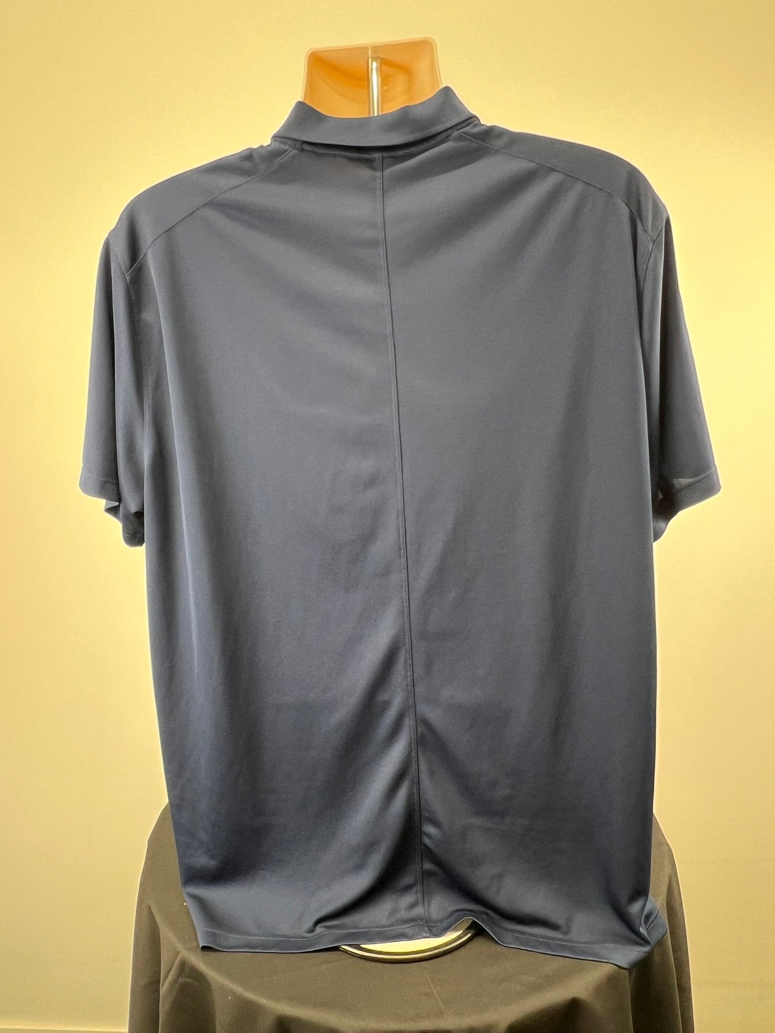 Back view of navy blue Nike short sleeve Dri-FIT polo shirt XL on mannequin