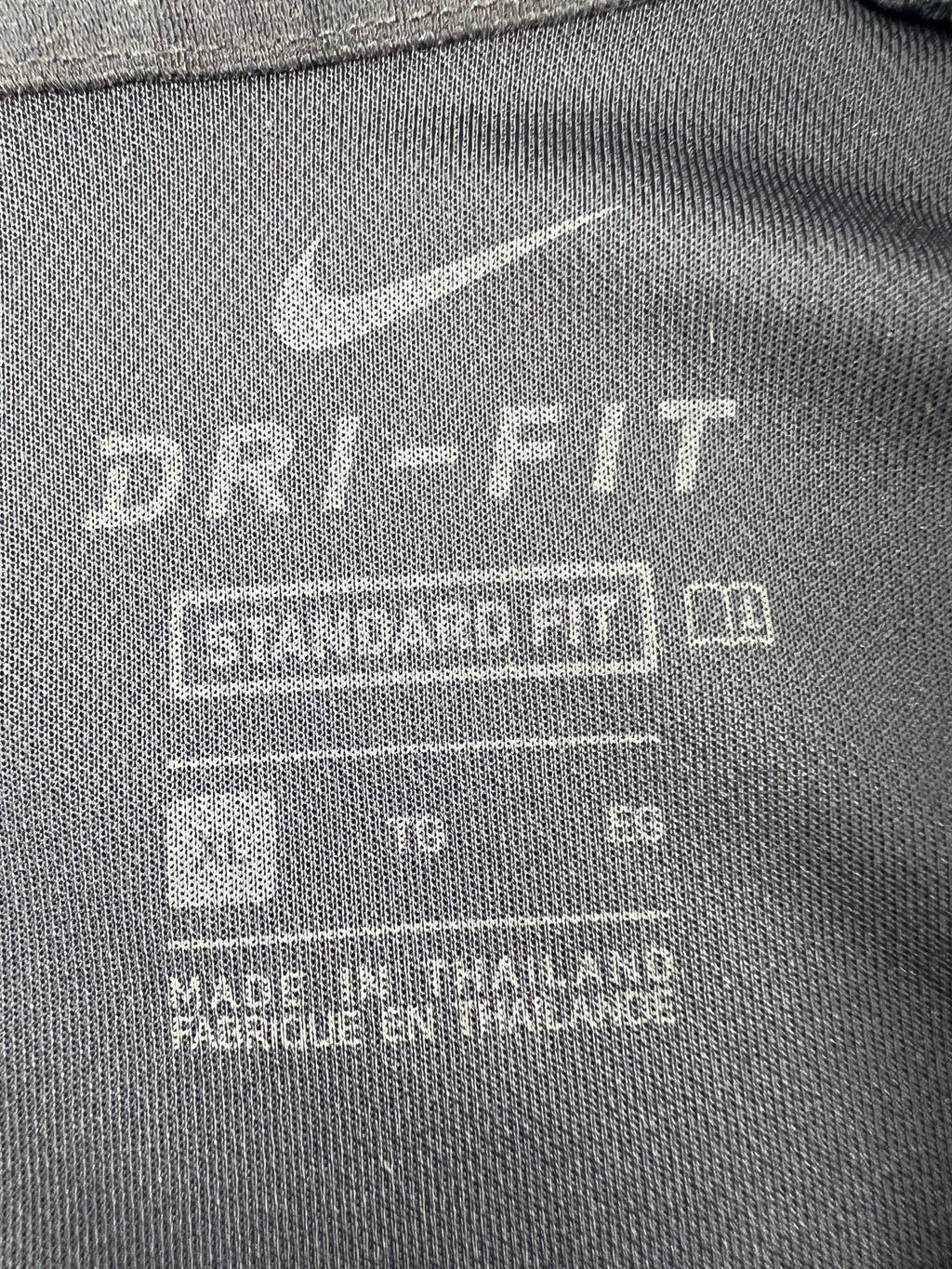 Nike Dri-FIT label and size XL tag on inside back of polo shirt