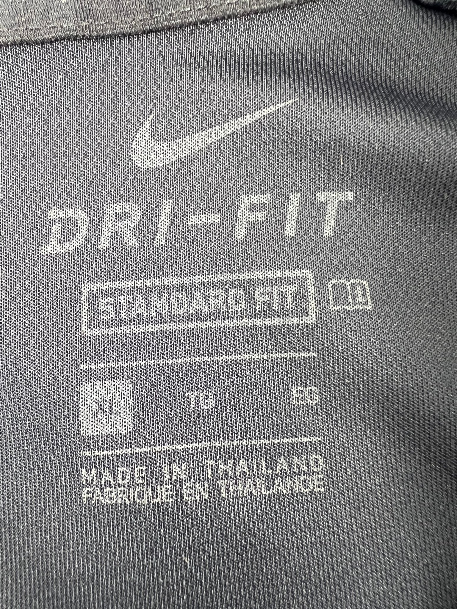 Nike Dri-FIT label and size XL tag on inside back of polo shirt