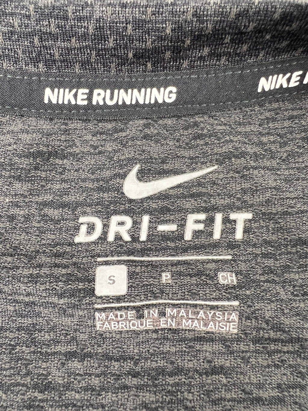Close-up of inside label showing Nike Dri-FIT branding and size small