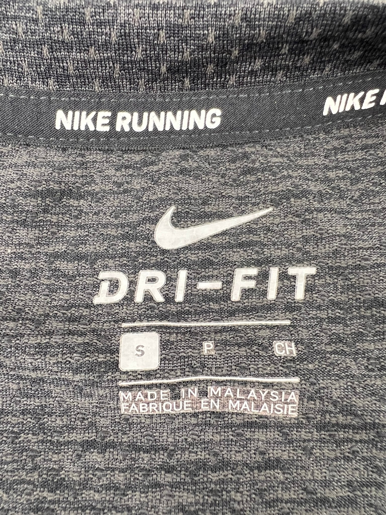 Close-up of inside label showing Nike Dri-FIT branding and size small